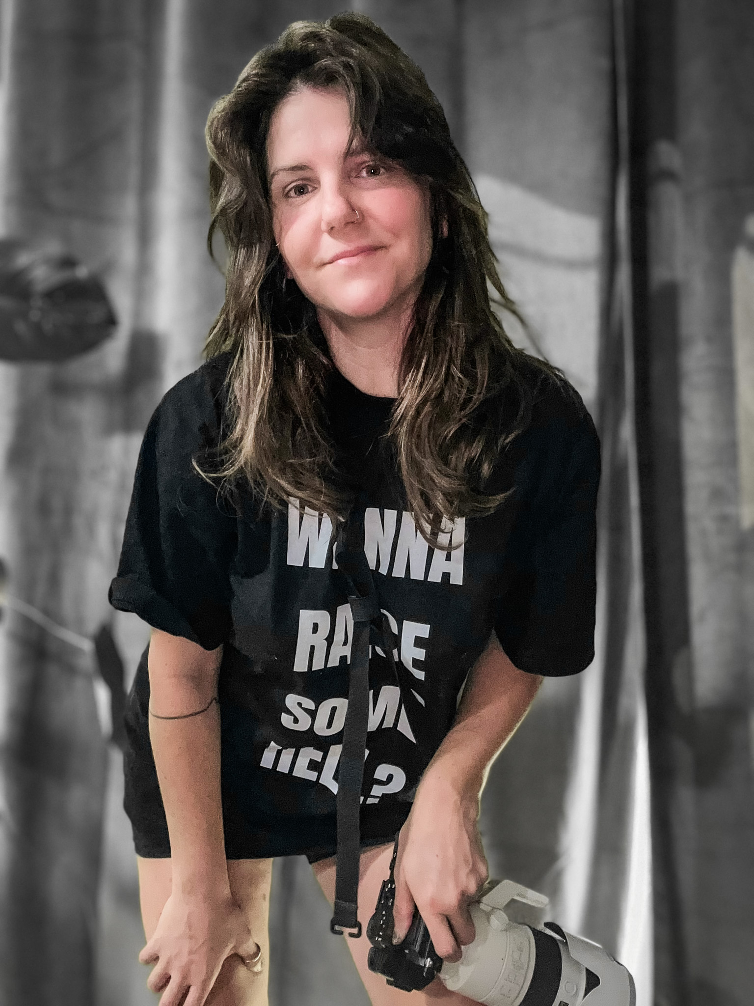 Tara of TaraLens Media — Denver documentary photographer holding a camera