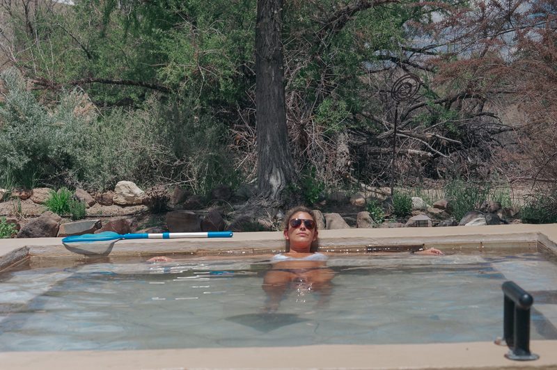 Woman relaxing in a natural hot spring pool during a wedding weekend in California