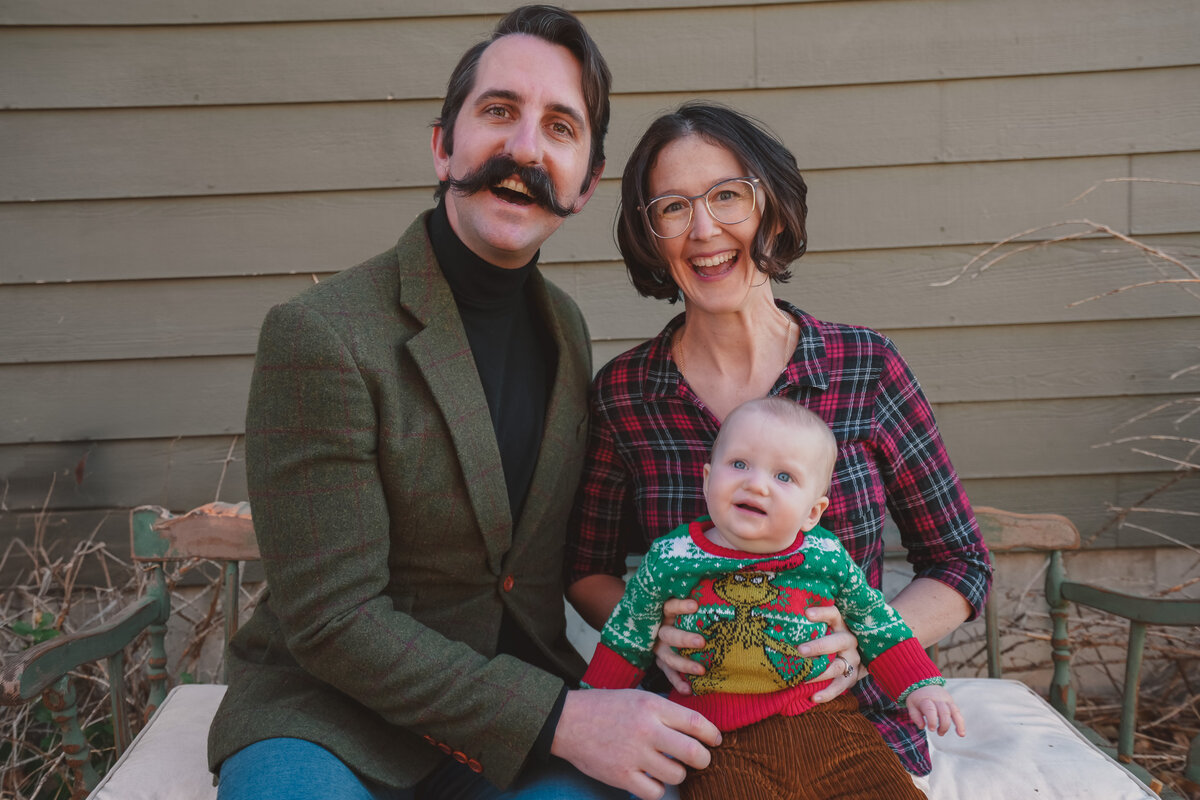 Parents laughing with their baby at a TaraLens Media fall mini session near Sacramento