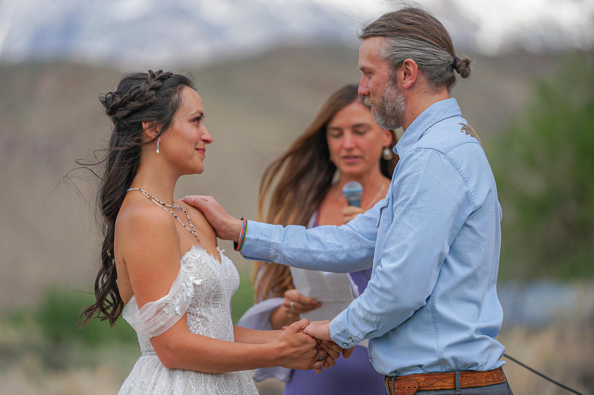 Couple exchanging vows during an intimate outdoor elopement ceremony in Colorado with a mountain backdrop
