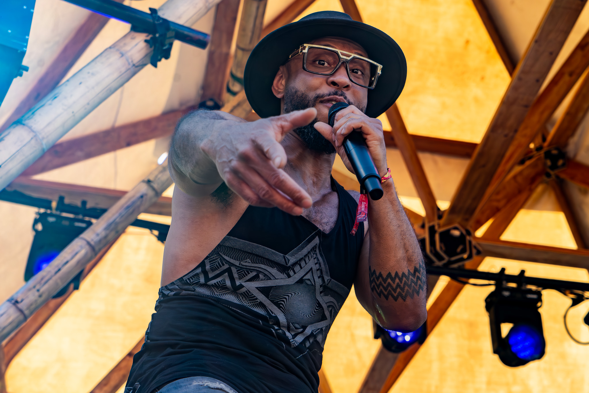 Live music performer under festival stage lighting at an outdoor concert