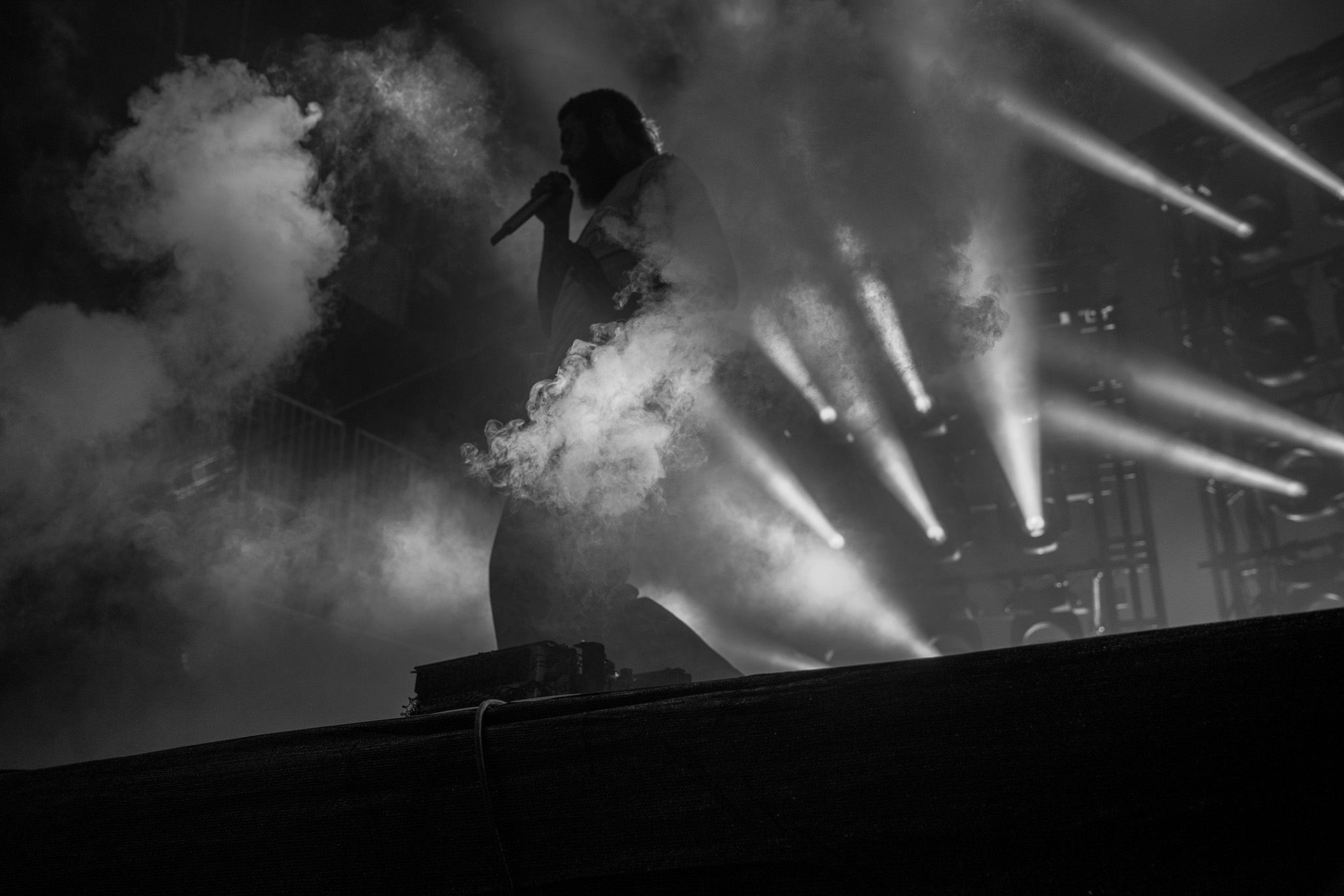 Performer silhouette with stage smoke and beams of light — Denver music photographer
