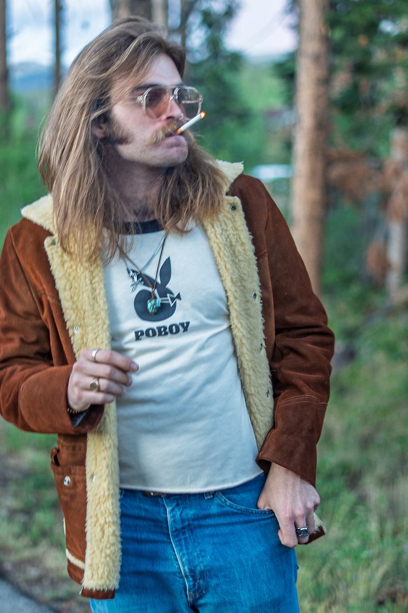 Portrait of a Rainy Eyes musician standing among the pines