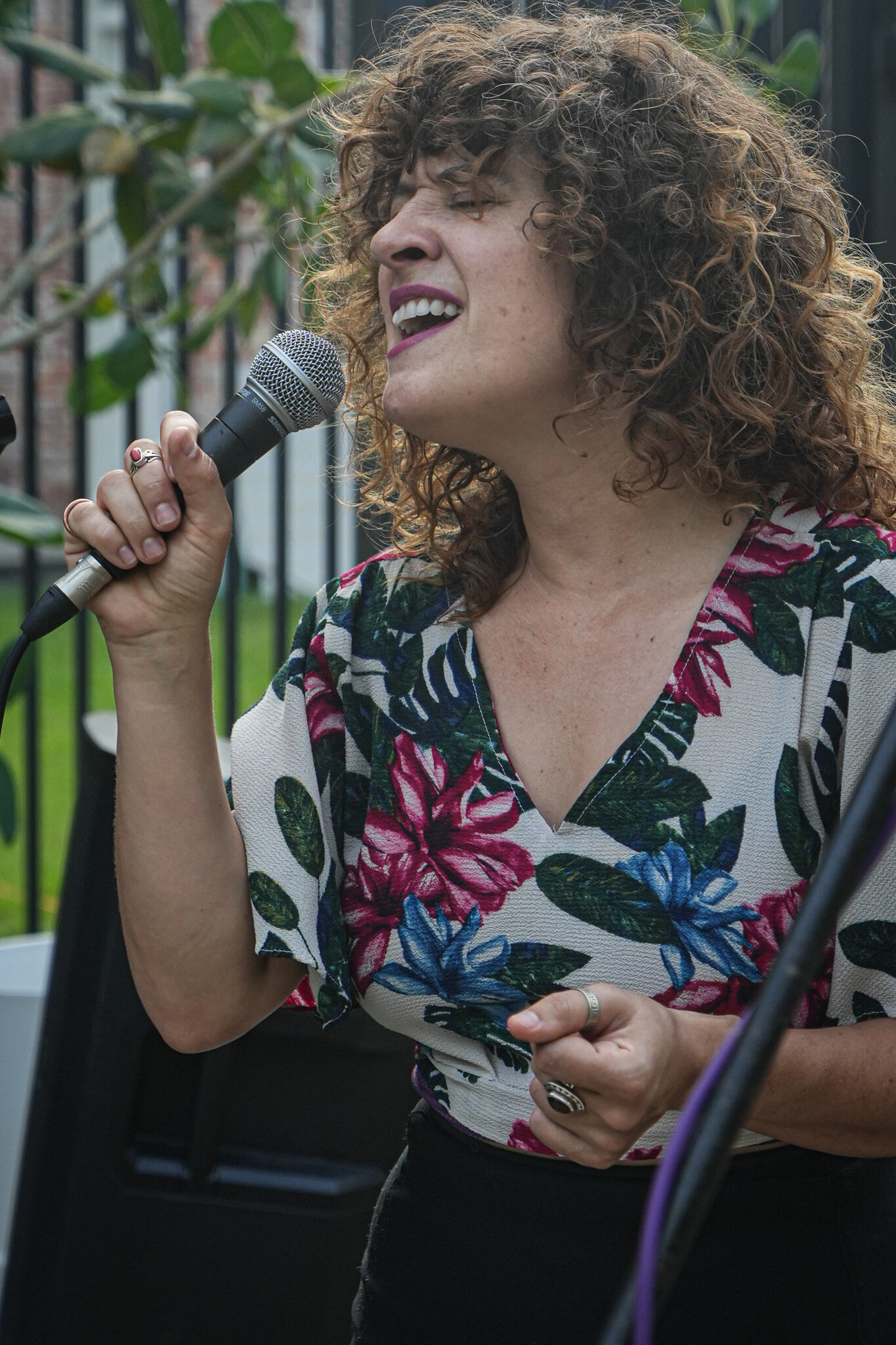 A vocalist sings at the microphone during a live jazz performance