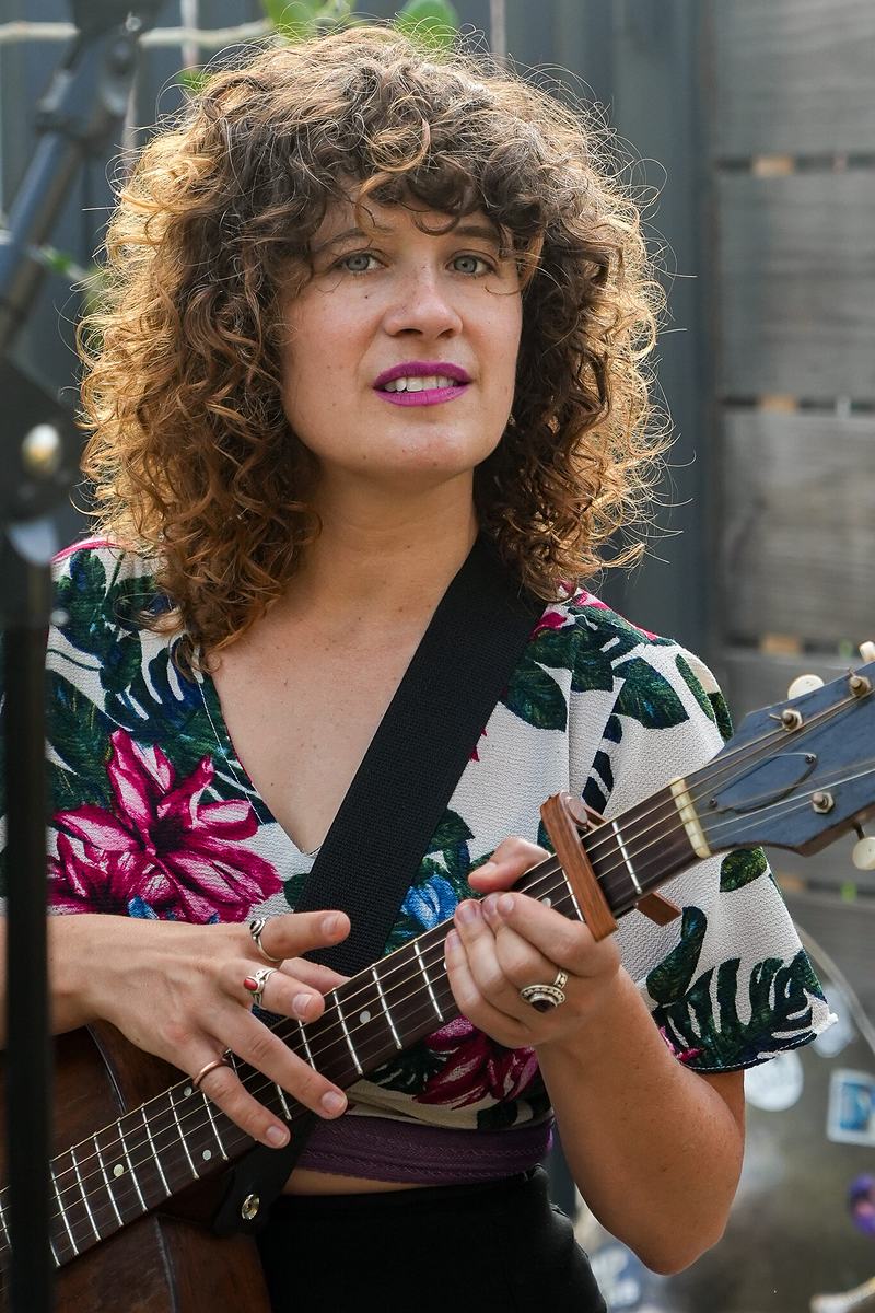 A musician plays the ukulele at a live jazz event, documentary music photography by Tara Lenehan