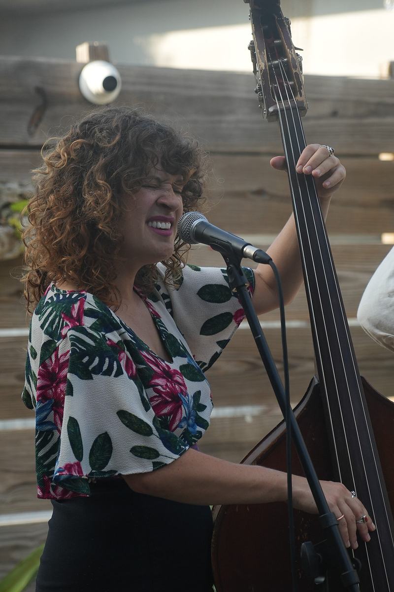 A musician plays the upright bass at a live jazz event, documentary music photography by Tara Lenehan