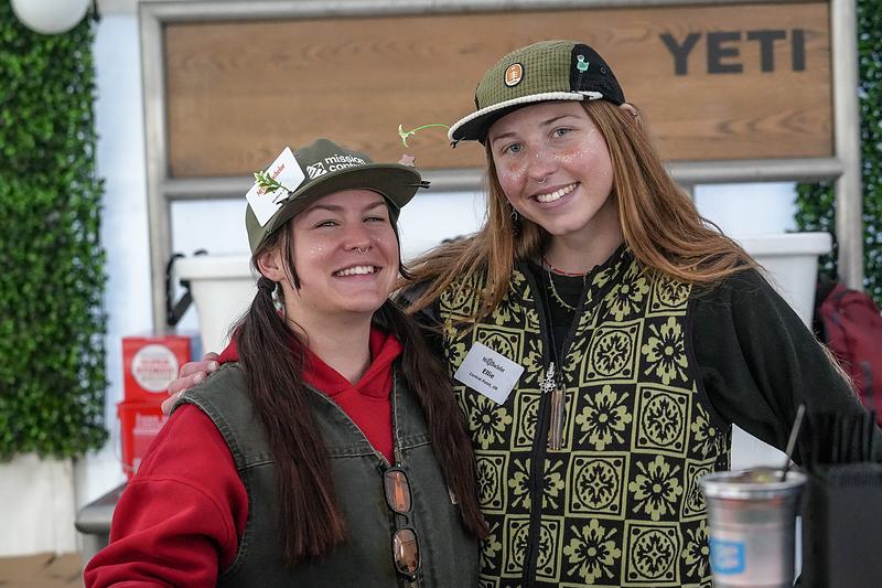 Two friends laughing together at the RendezVan 2026 outdoor music festival in Bend, documentary festival photography by Tara Lenehan