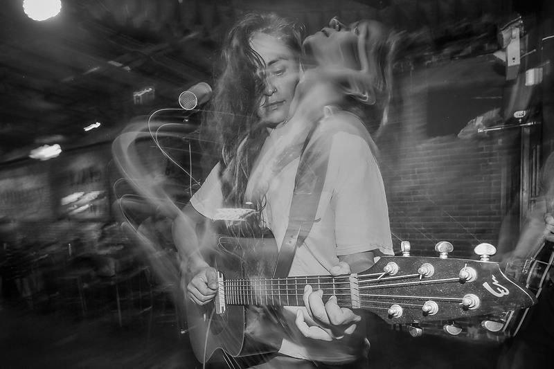 Black and white long exposure of an acoustic guitarist — live music documentary photography
